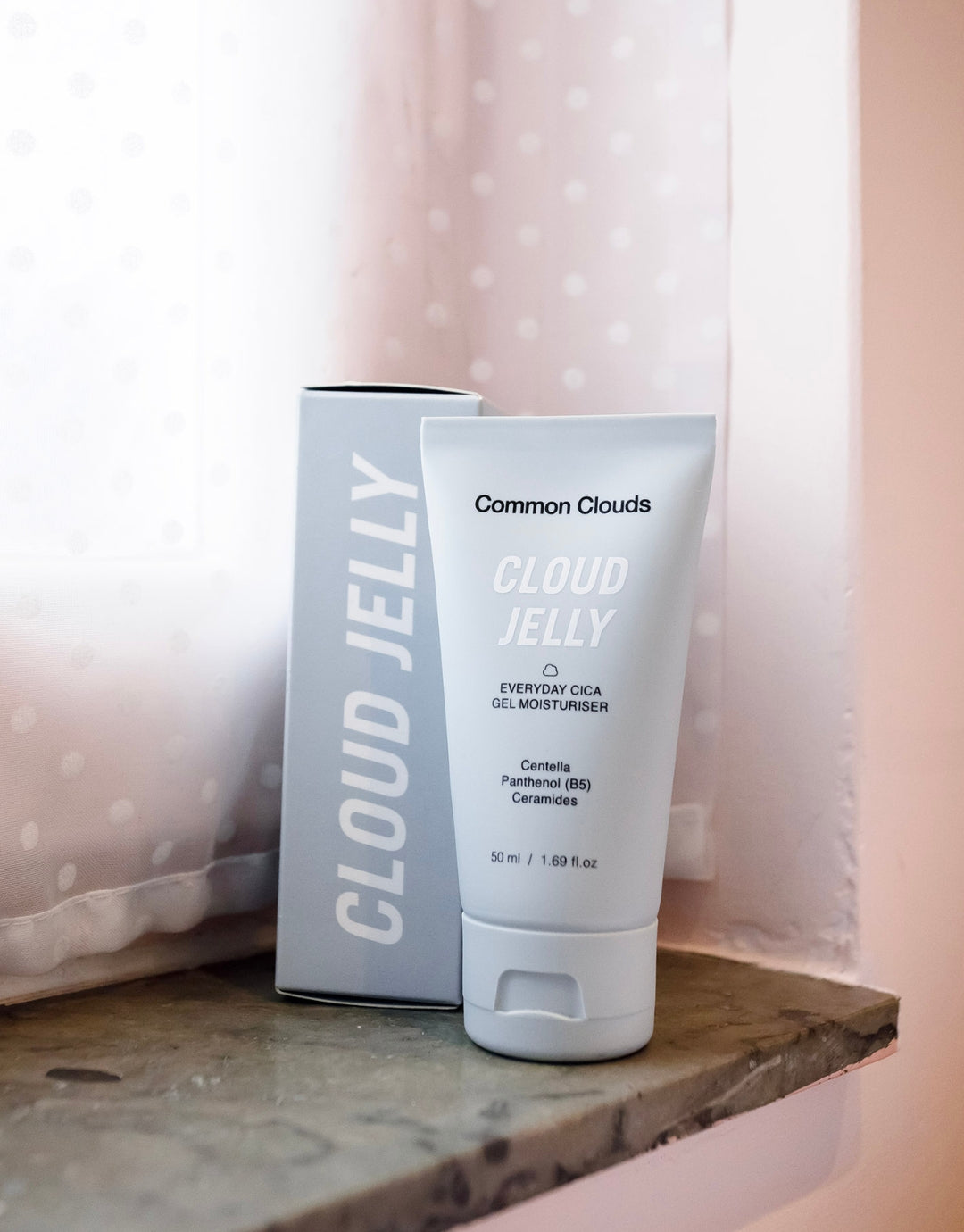 Cloud Jelly moisturiser from Common Clouds is being placed in a windowsill.