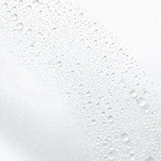 Textured white surface with water droplets