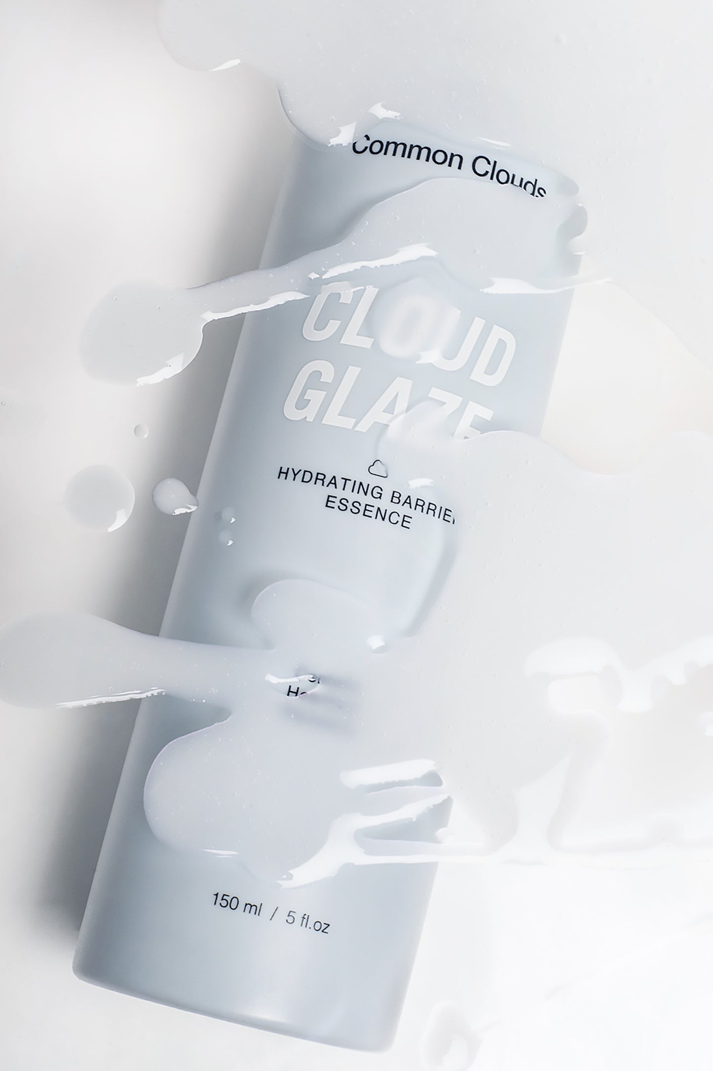 Blue bottle labeled 'Cloud Glaze' on a light gray background