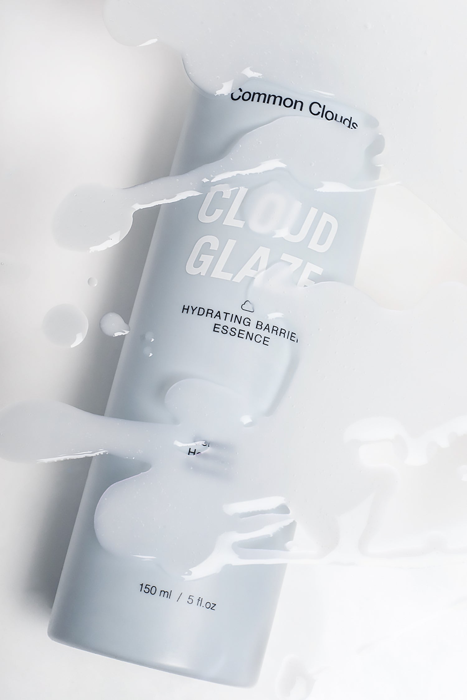 Blue bottle labeled 'Cloud Glaze' on a light gray background