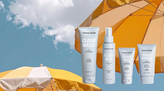 Common Colds skincare products with orange and yellow umbrellas against a blue sky.